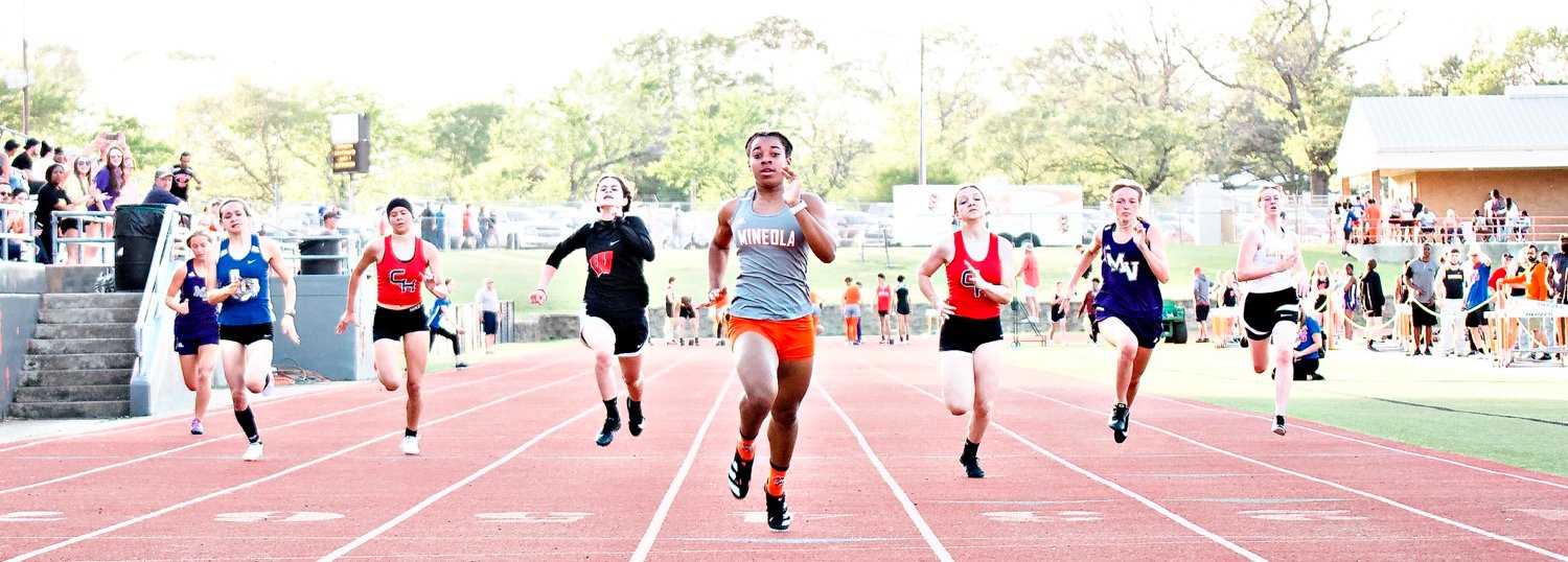 Abby Kratzmeyer (center) ran away with the 100 meter dash in 12.51 seconds, over a quarter-second faster than the field. Cicaly Bravo of Quitman (left in blue) finished 4th, qualifying for area. [run, don't walk, for more shots]